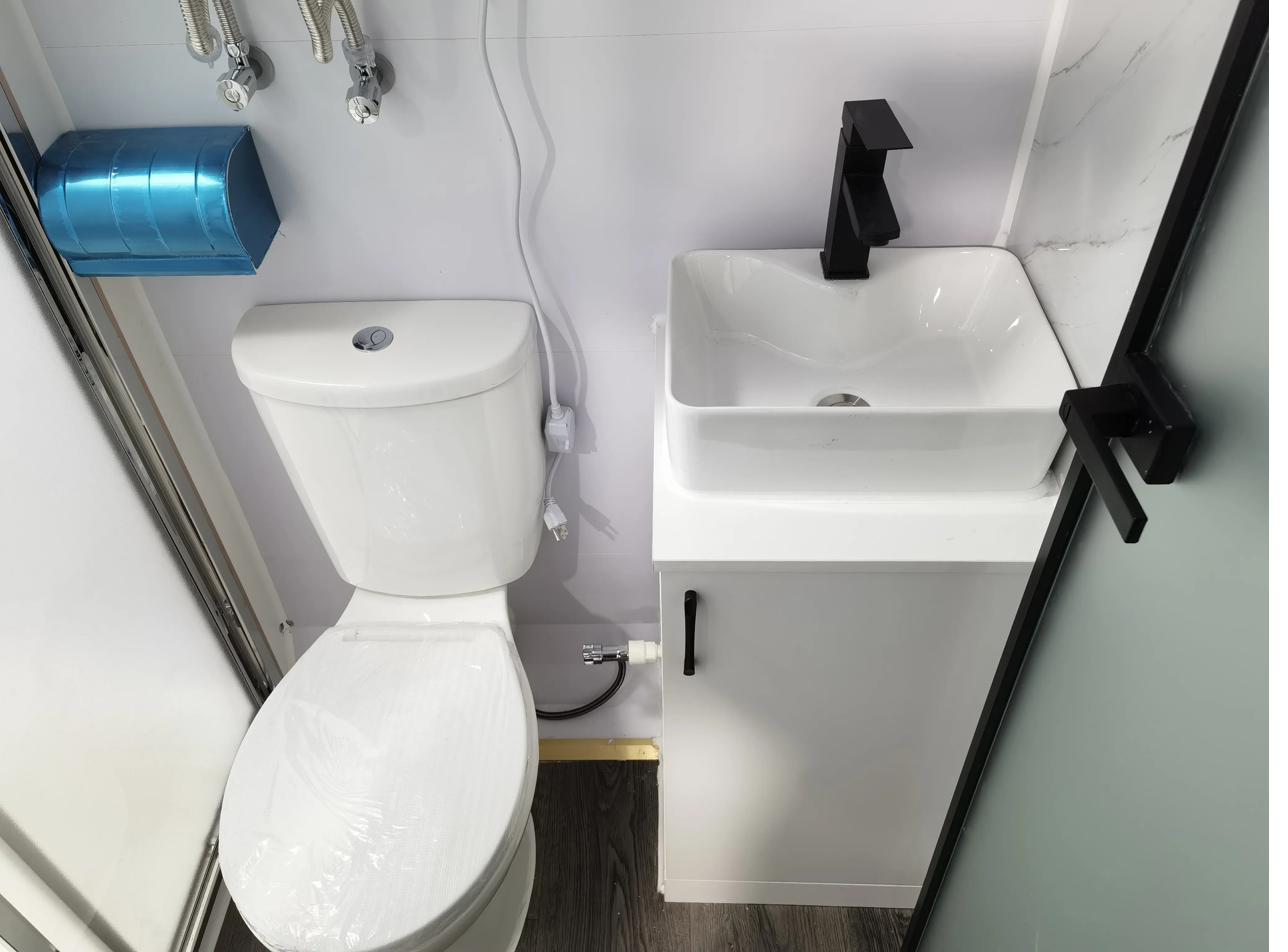 Standard 20ft tiny house compact bathroom — toilet and vessel sink in efficient layout